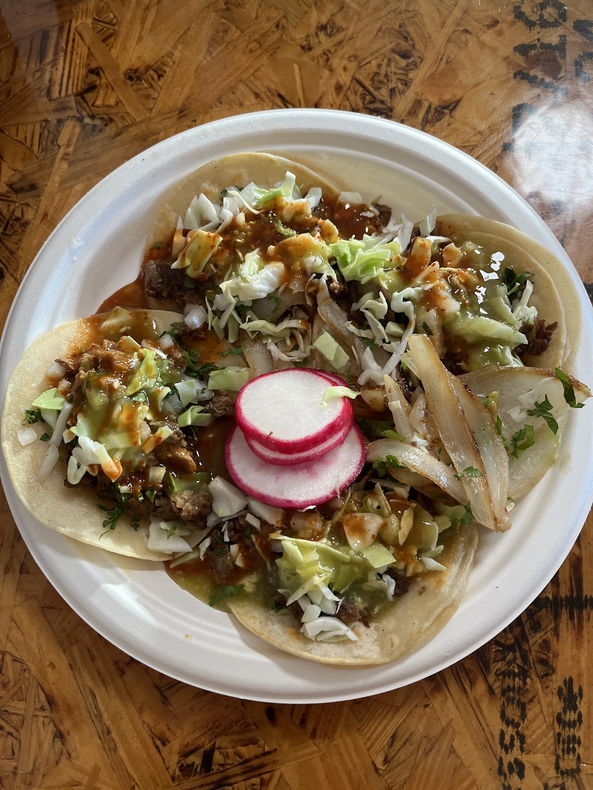 A plate of street tacos with onion, cabbage, salsa and radish at La Fonda Colima